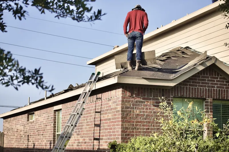 Professional roofer working on a residential roof in Dempsey Landing